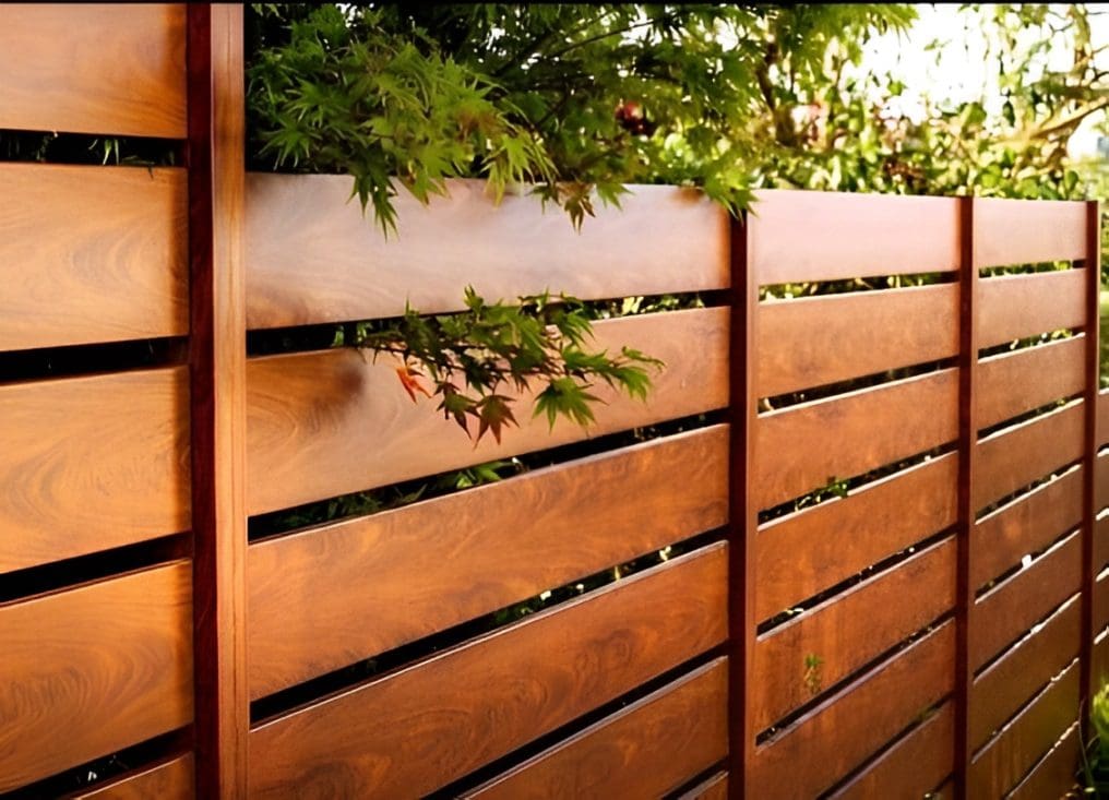 Modern wooden fence with horizontal slats and greenery above.